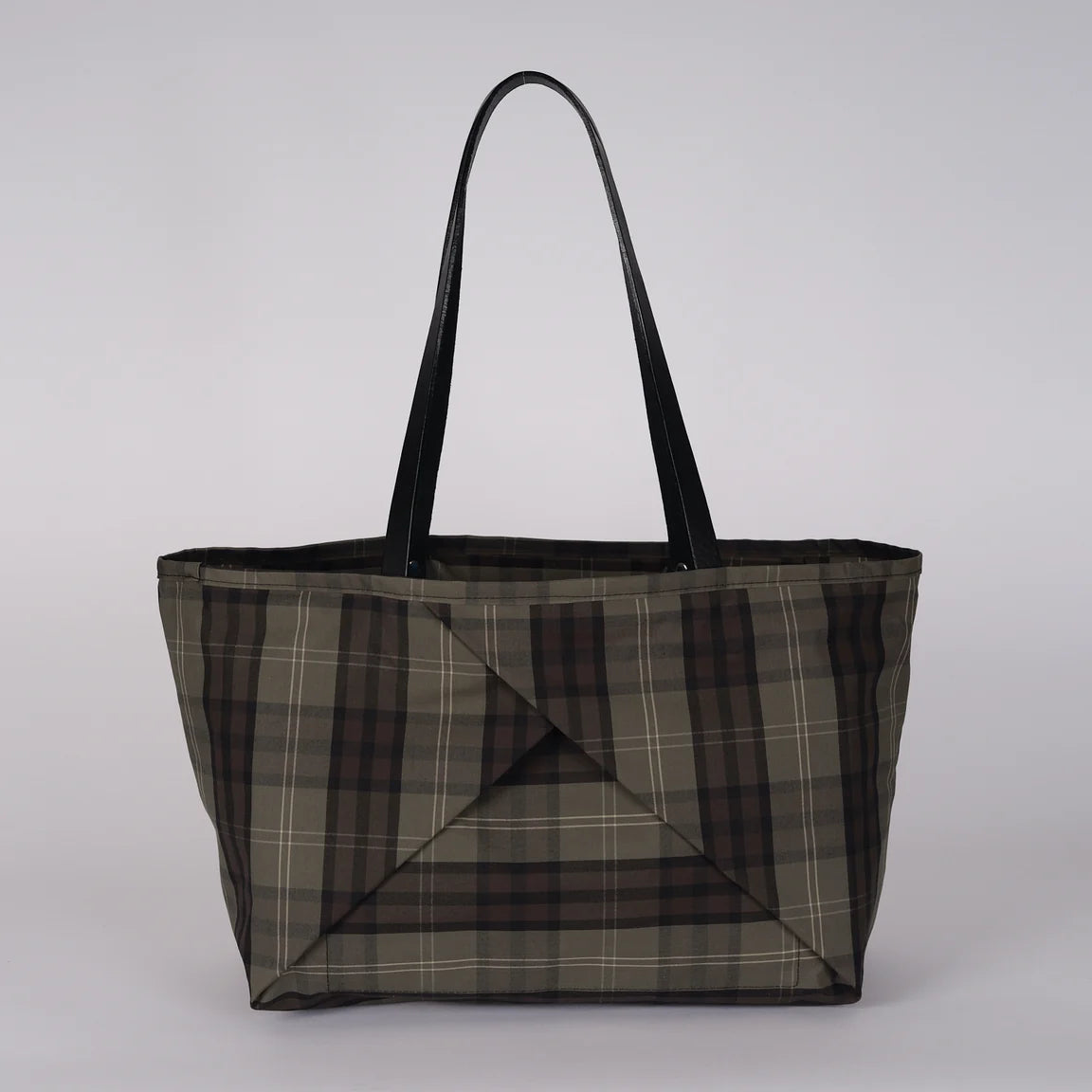 A large tote bag with a brown, gray, and black plaid pattern and black shoulder straps, shown against a plain white background.