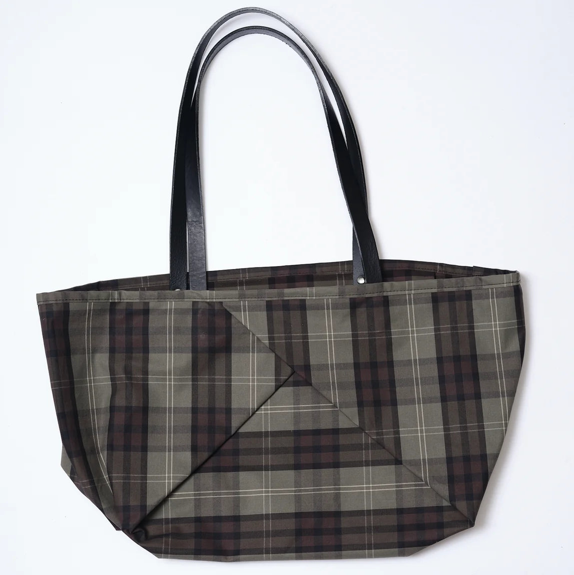 A large tote bag with a brown, gray, and black plaid pattern and black shoulder straps, shown against a plain white background.