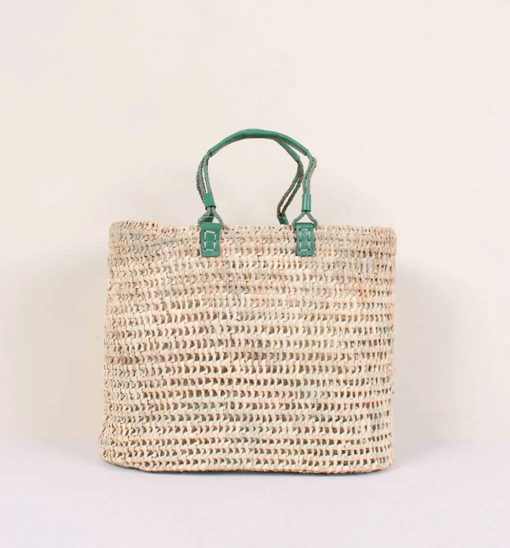 woven straw basket with green handles