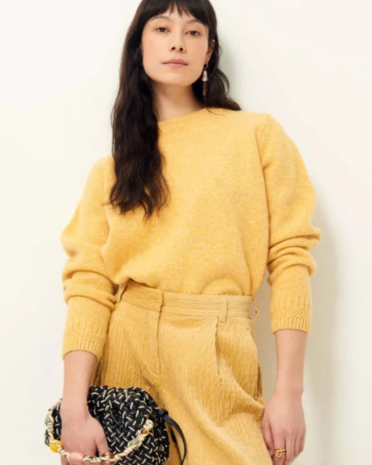 Sessun Silty round neck sweater worn tucked in pants at the waist. Stitch detail on the long sleeve cuff. 