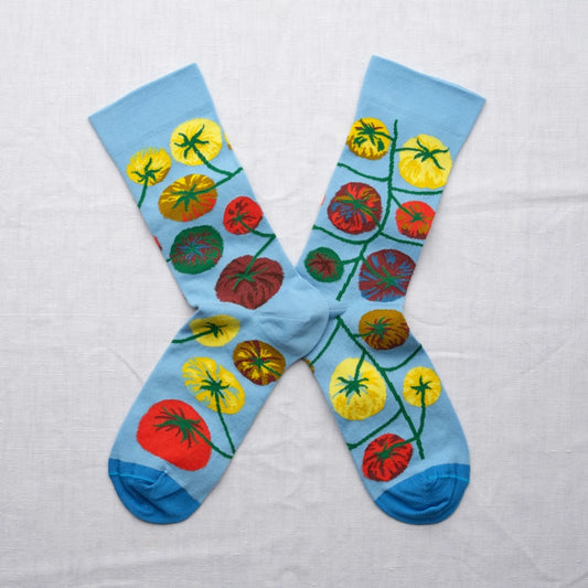 Colorful socks with tomato design on a light blue background