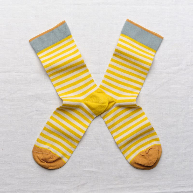 Pair of yellow and white striped socks with blue trim