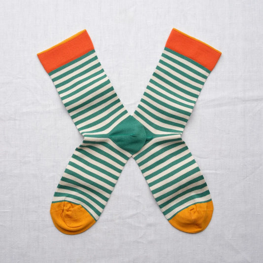 A pair of striped socks with green, orange, and yellow.