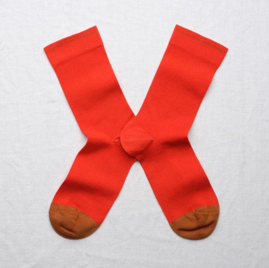 A pair of red socks with brown toe 