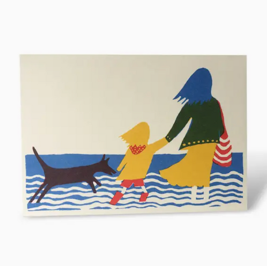 Greeting card with image of woman holding child's hand and black dog beside the sea