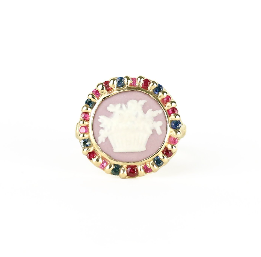 Round ring with antique Wedgewood cameo garland motif on purple background surrounded by blue and pink sapphires and rubies