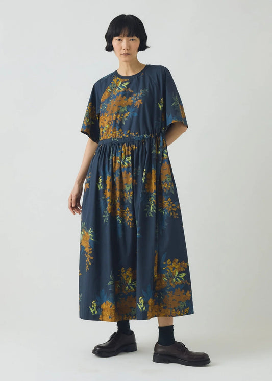 Woman wearing a dark floral dress on a white background