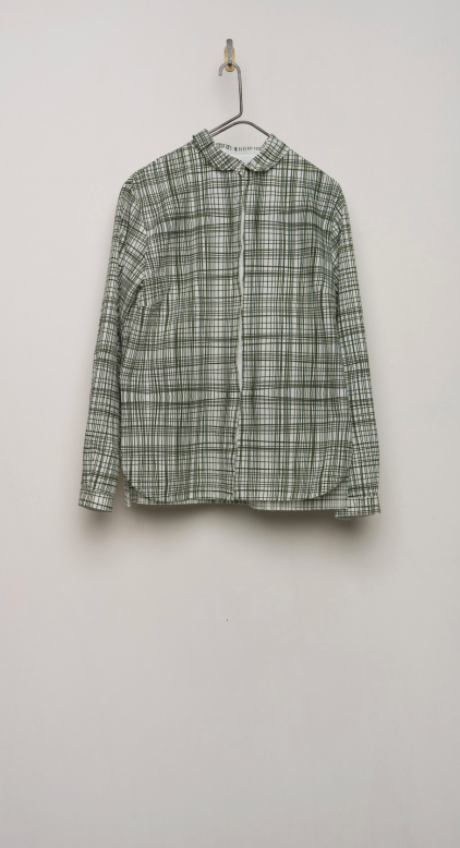 Hanging olive plaid shirt shown against a light grey background.