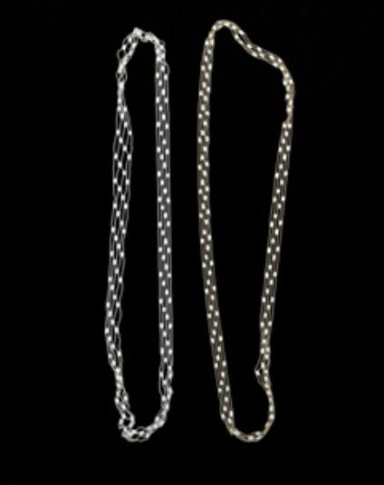 Two necklaces with chain patterns shown against a black background.