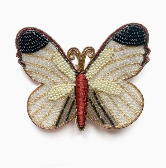 White butterfly with black and orange detail beaded brooch