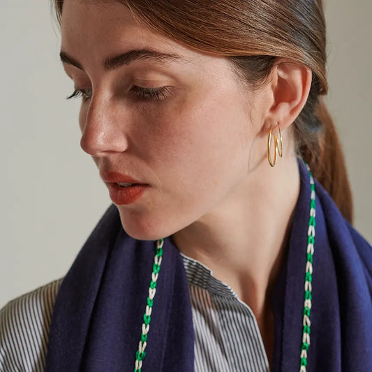 Night color scarf with green and white embroidery border stitch. Worn over a stripe stand up collar shirt