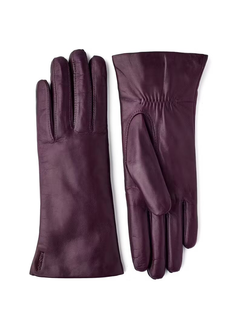 Pair of purple leather gloves on a transparent background