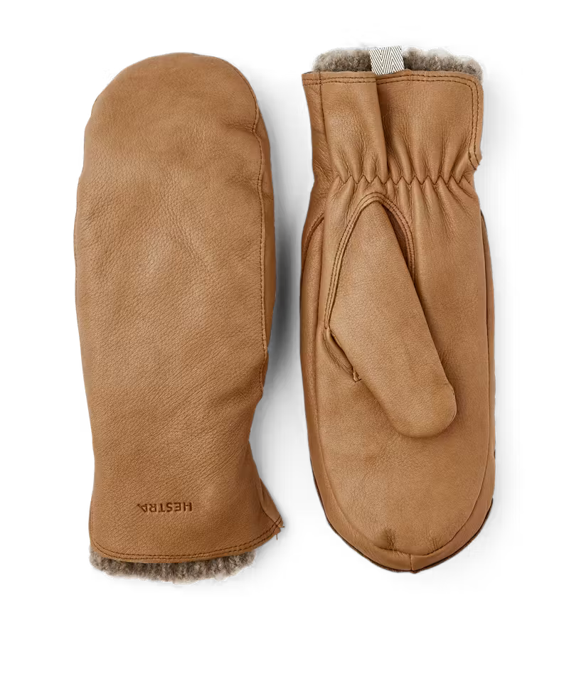 Pair of brown leather mittens with fur lining on a white background