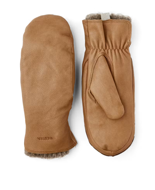 Pair of brown leather mittens with fur lining on a white background