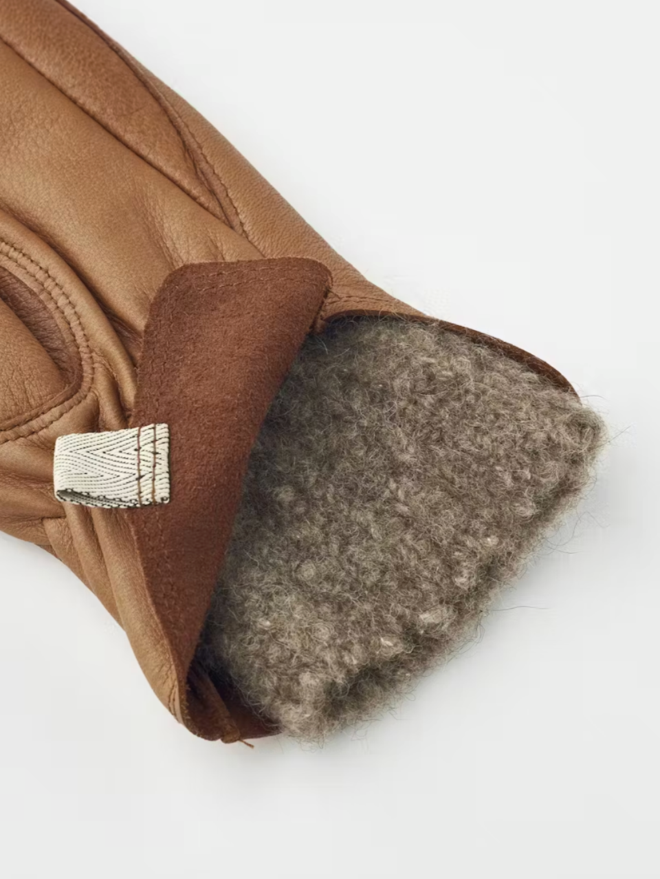 Brown leather glove with fur lining on a white background