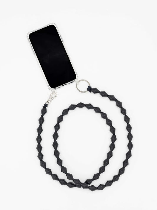 A geometric black beaded phone strap with a silver clasp and key ring, shown attached to a smartphone on a plain white background.