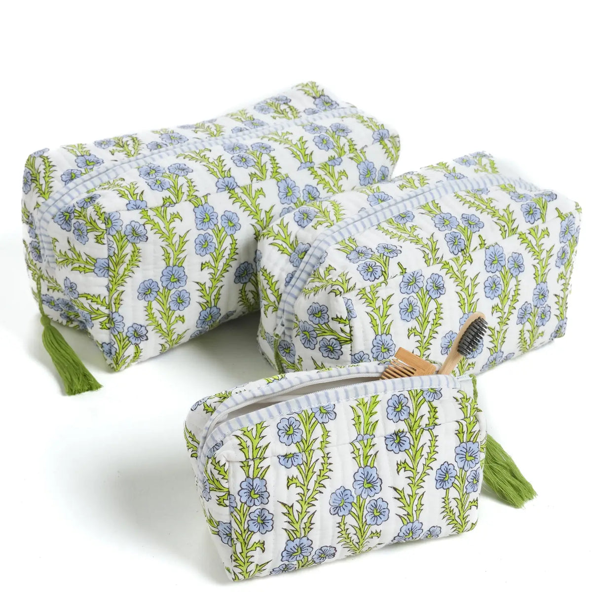 Set of three floral-patterned pouches with tassels on a white background