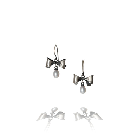 Oxidized Sterling Silver Bow Earrings with a white pearl against a white background