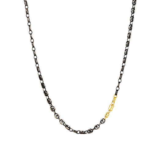 Necklace with black and gold chain on a white background