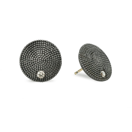 Black textured stud earrings with clear gemstones on a white background