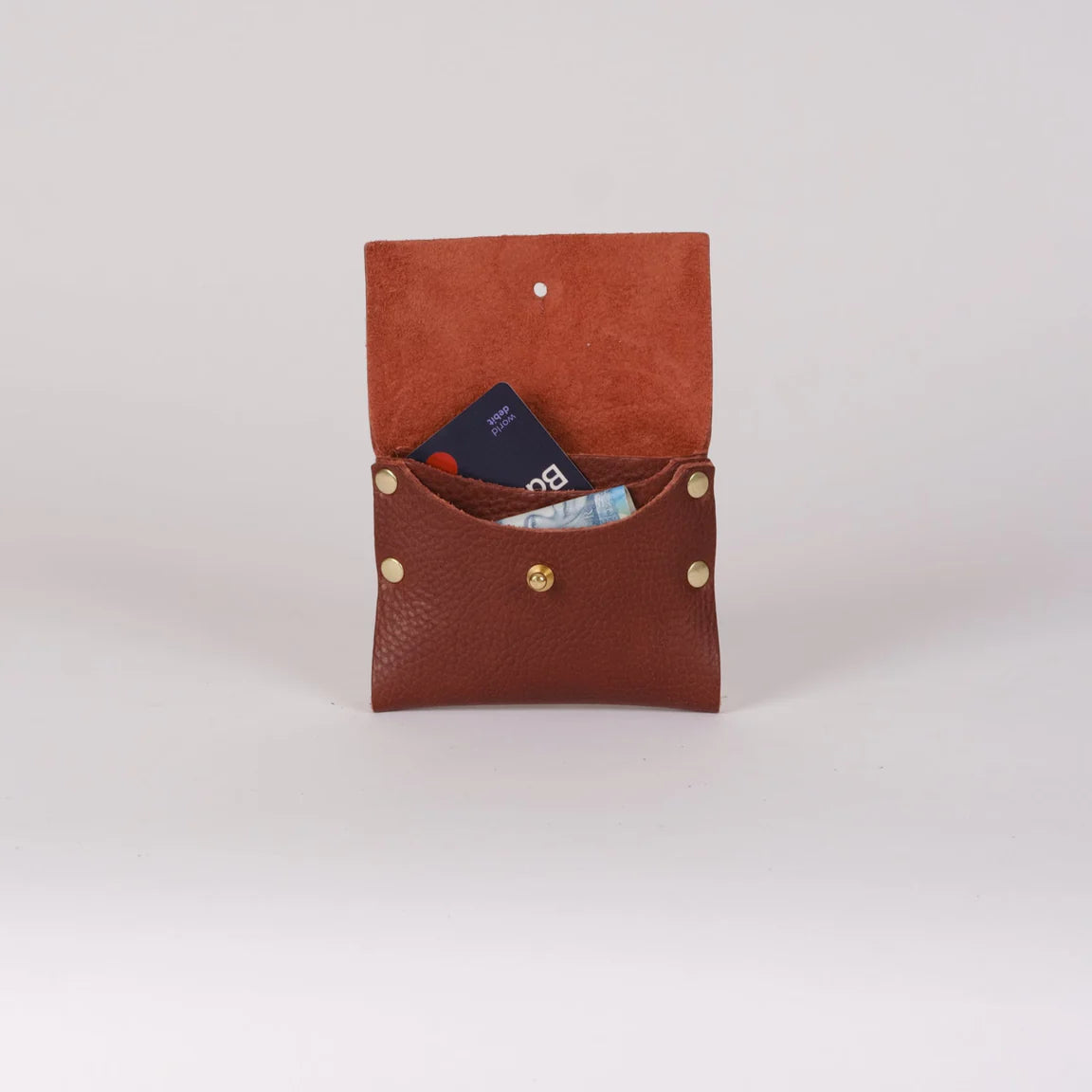 Brown leather wallet with gold buttons on a light gray background