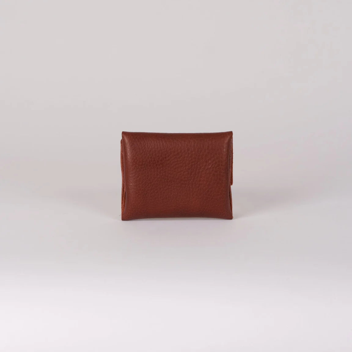 Brown leather wallet on a light gray background