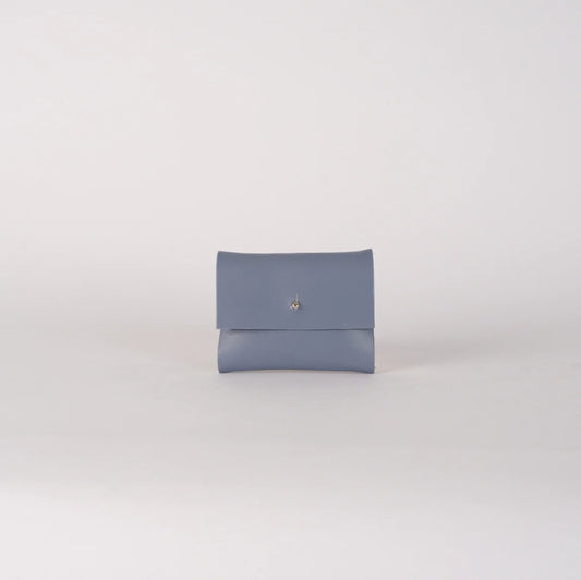 Blue clutch bag on a light gray background