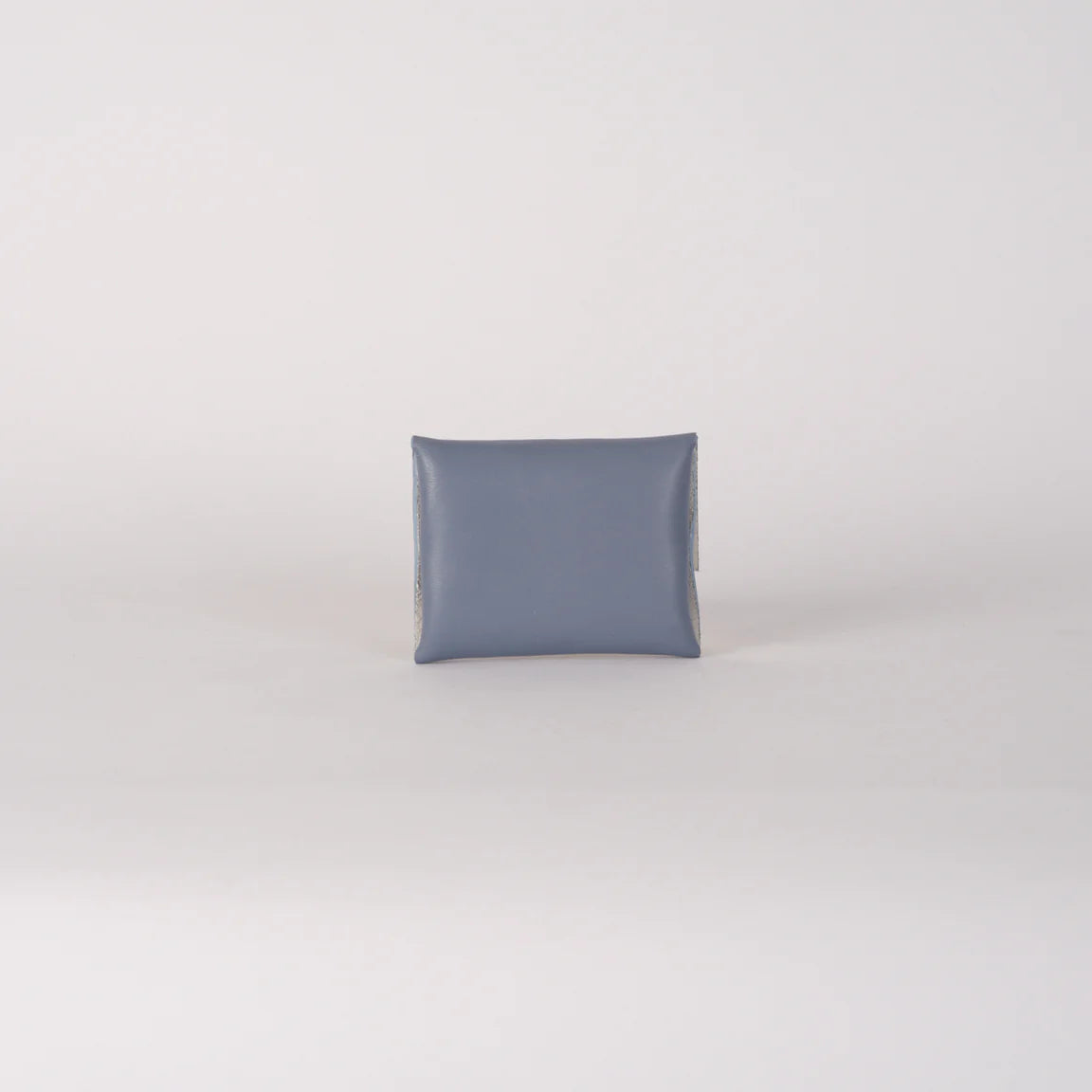 Solid gray pillow on a light gray background