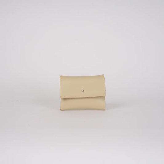 Beige clutch bag on a light gray background