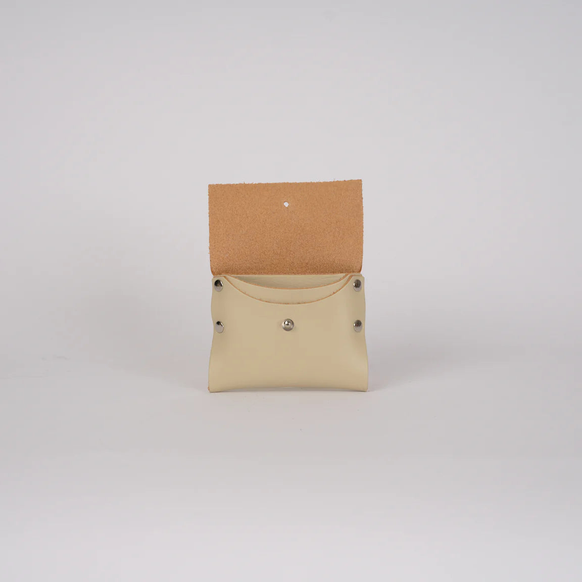 Small beige pouch with a brown flap on a light gray background