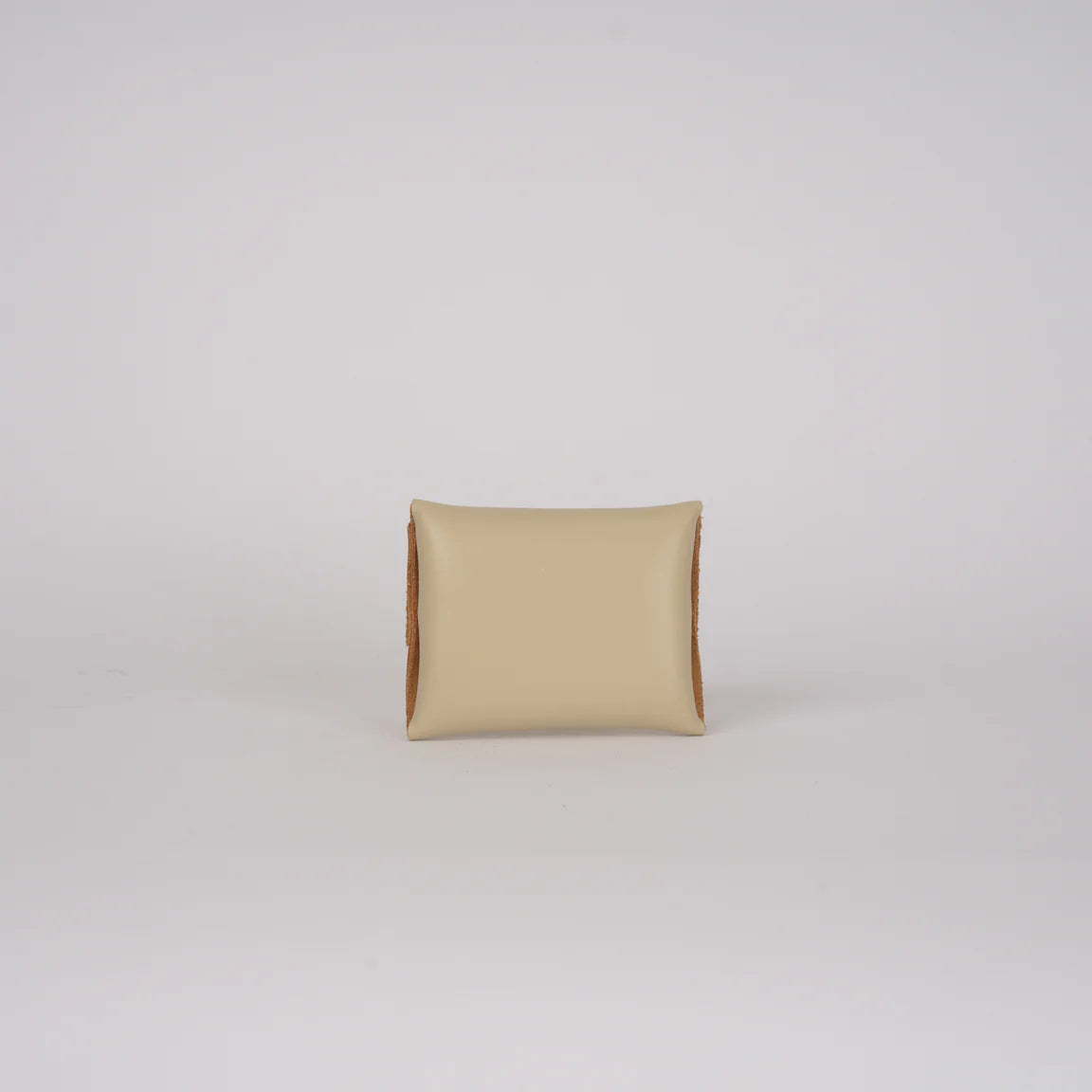 Beige pillow on a light gray background