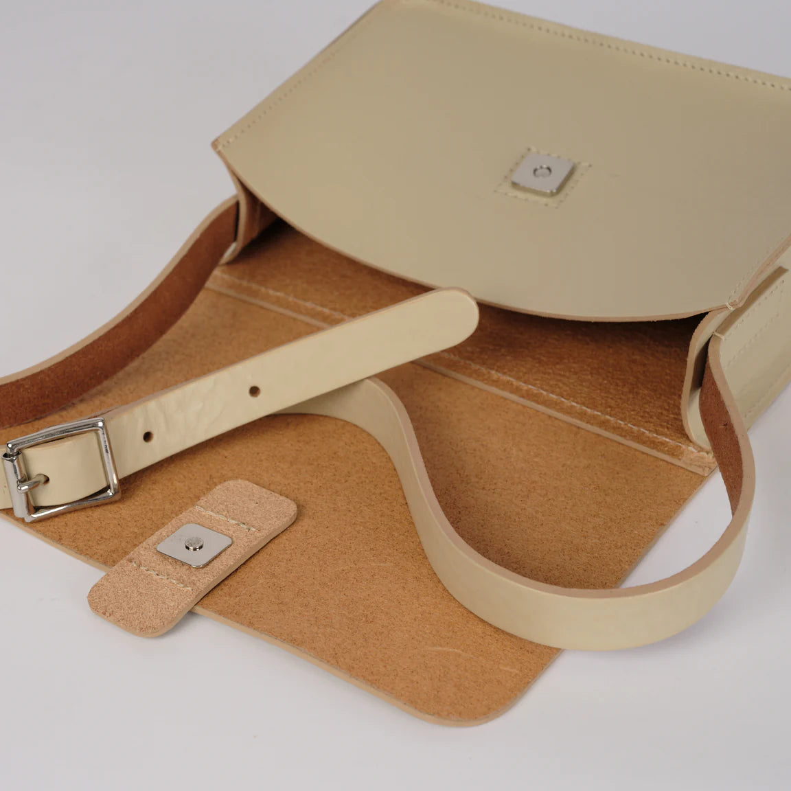 Beige handbag with a strap on a light gray background