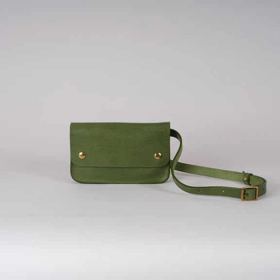 Picture of green handbag on grey background. Font view.