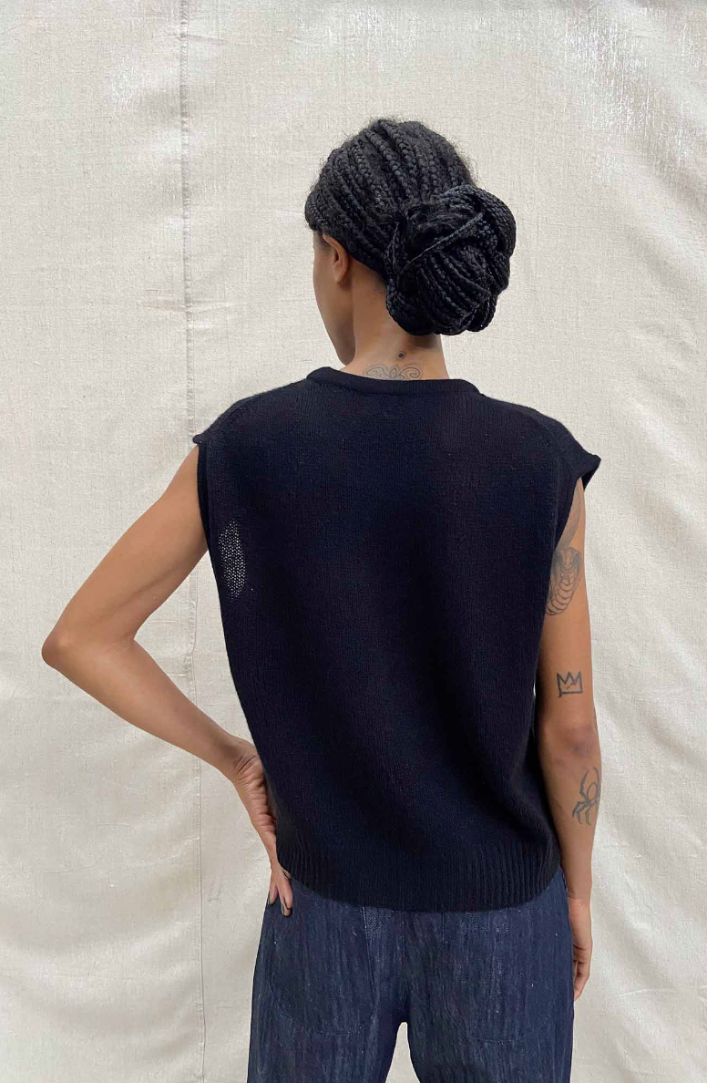 Back view of black sleeveless shell. Jersey knit with ribbed waist