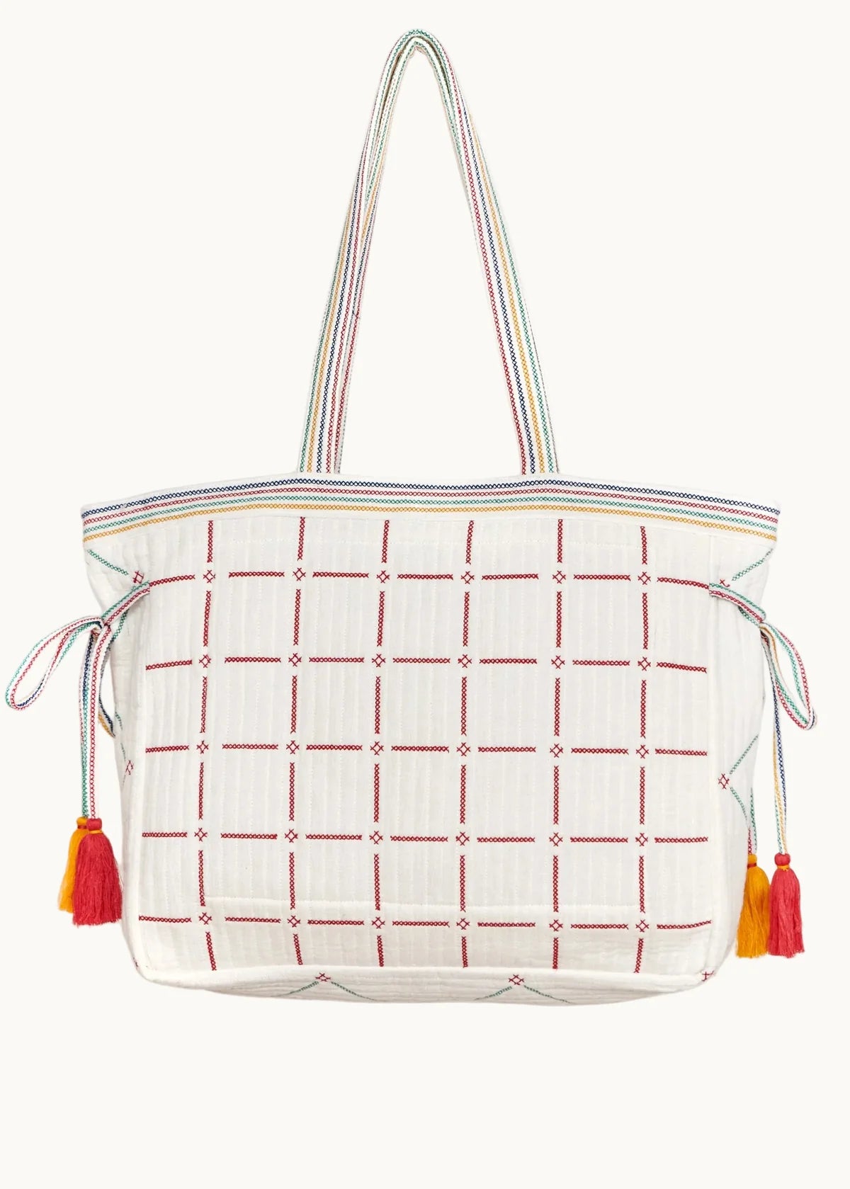 White tote bag with red grid pattern and colorful tassels on a white background