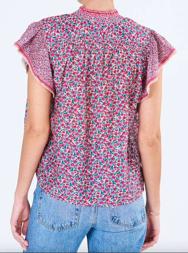 Back view of the mini floral print top with flutter sleeve. Shown with blue wash jeans