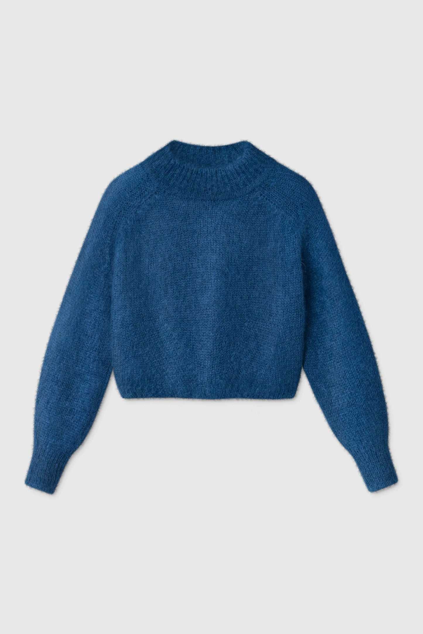 A textured blue cropped knit sweater with long sleeves and a ribbed crew neck, displayed against a light gray background.