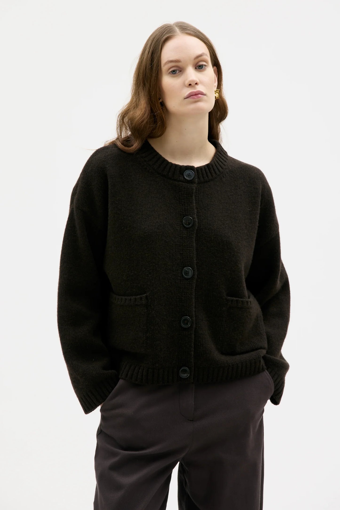 Woman wearing a brown cardigan on a white background
