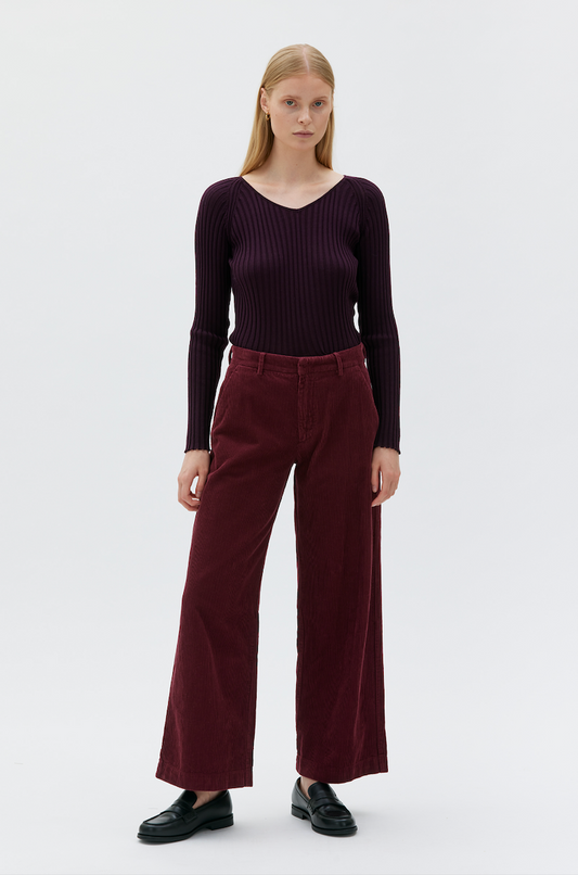 woman wearing burgundy pants and long sleeve t-shirt