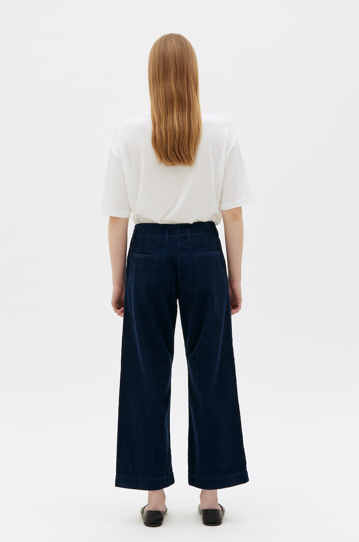 rear view of Woman wearing royal blue corduroy pants with white t-shirt