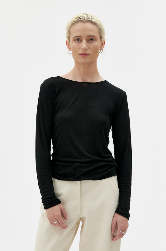 Woman wearing long sleeved black top