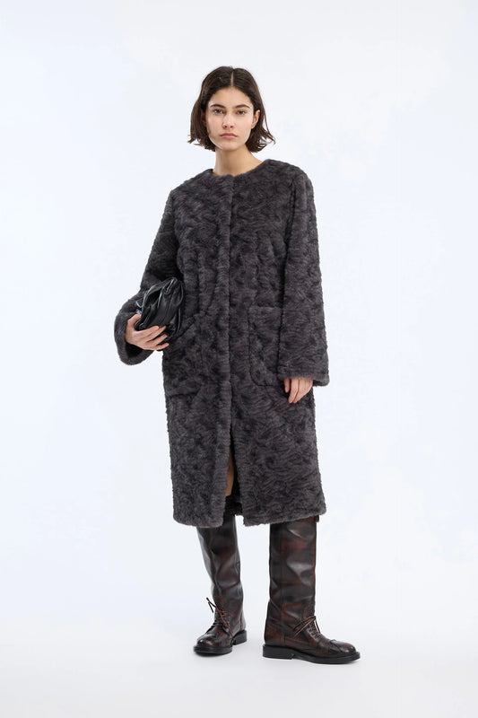 A dark gray textured fleece jacket with a subtle tonal pattern, worn on a posing model.