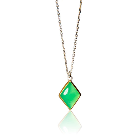 Lozenge shaped chrysoprase pendant set in gold bezel on silver chain.