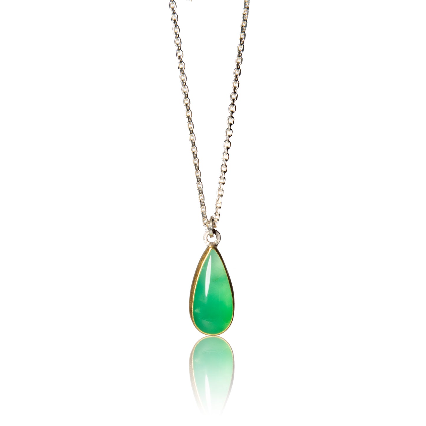 Teardrop shaped chrysoprase pendant set in gold bezel on silver chain.