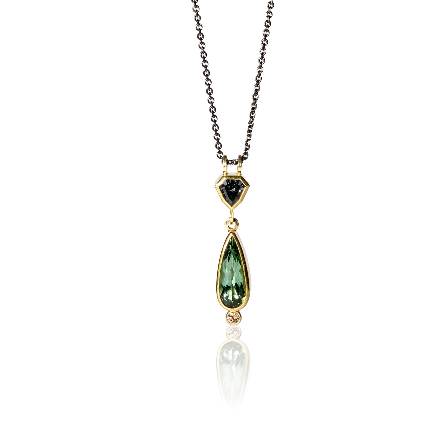 Pendant with green tourmaline, grey spinel and diamond on blackened steel chain by Sam Woehrmann