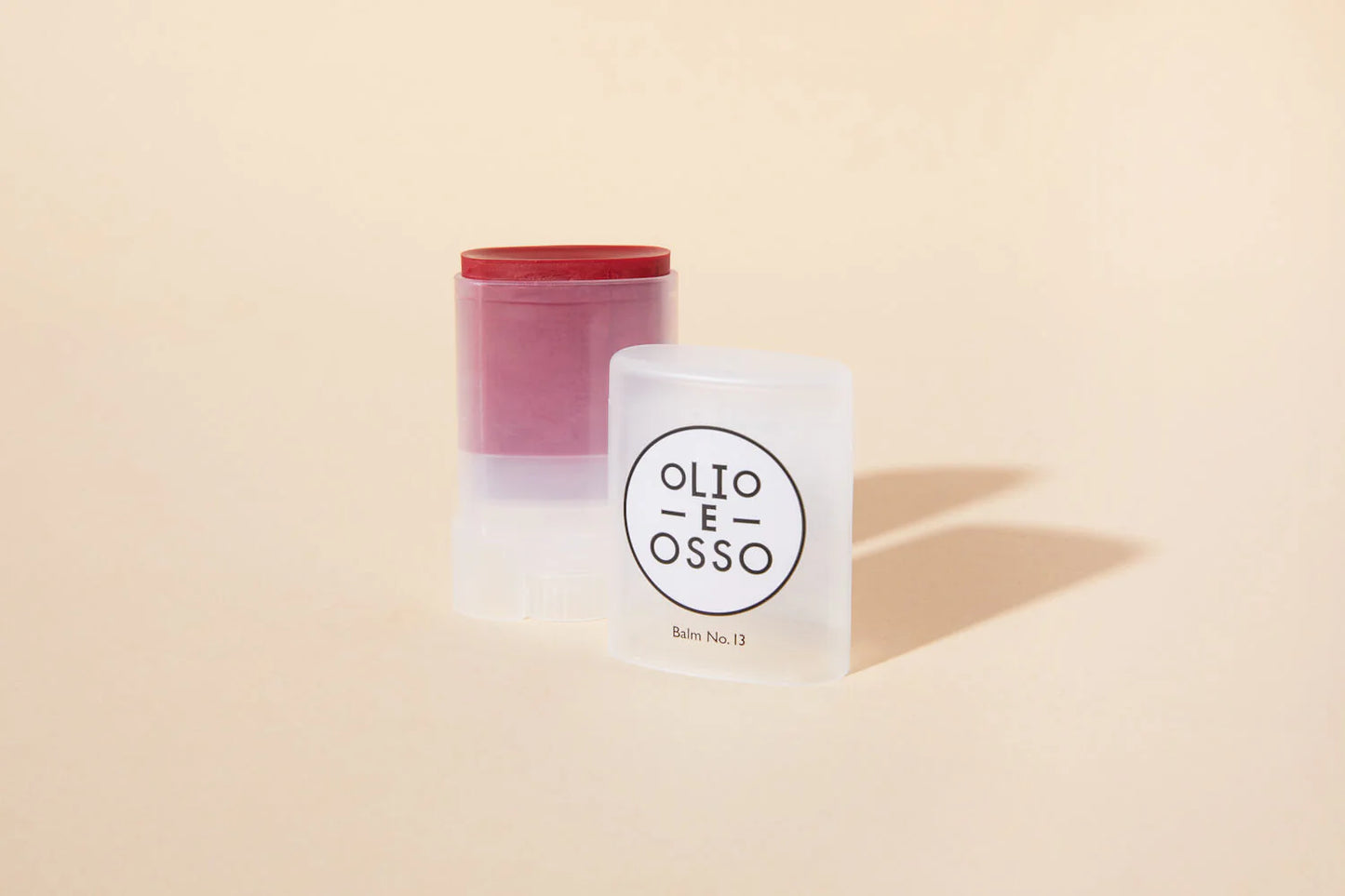 Two containers with 'Olio E Osso' branding on a beige background