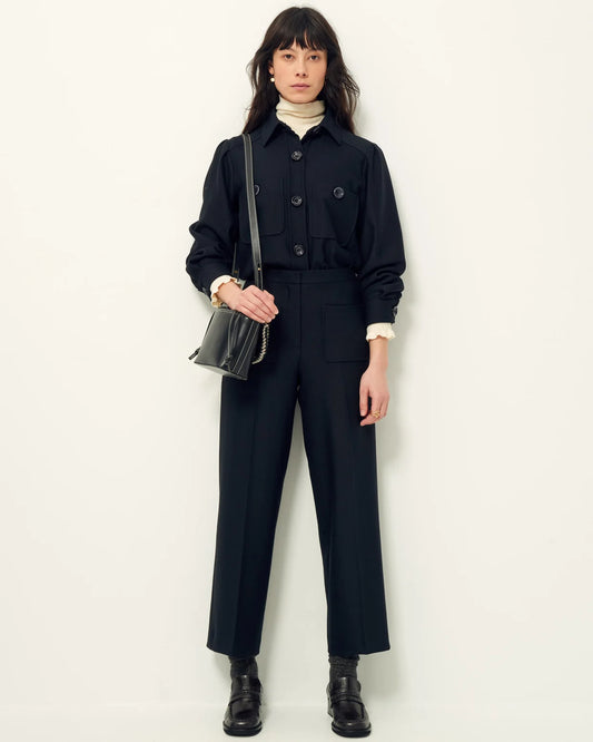 Person wearing a black outfit with a white background