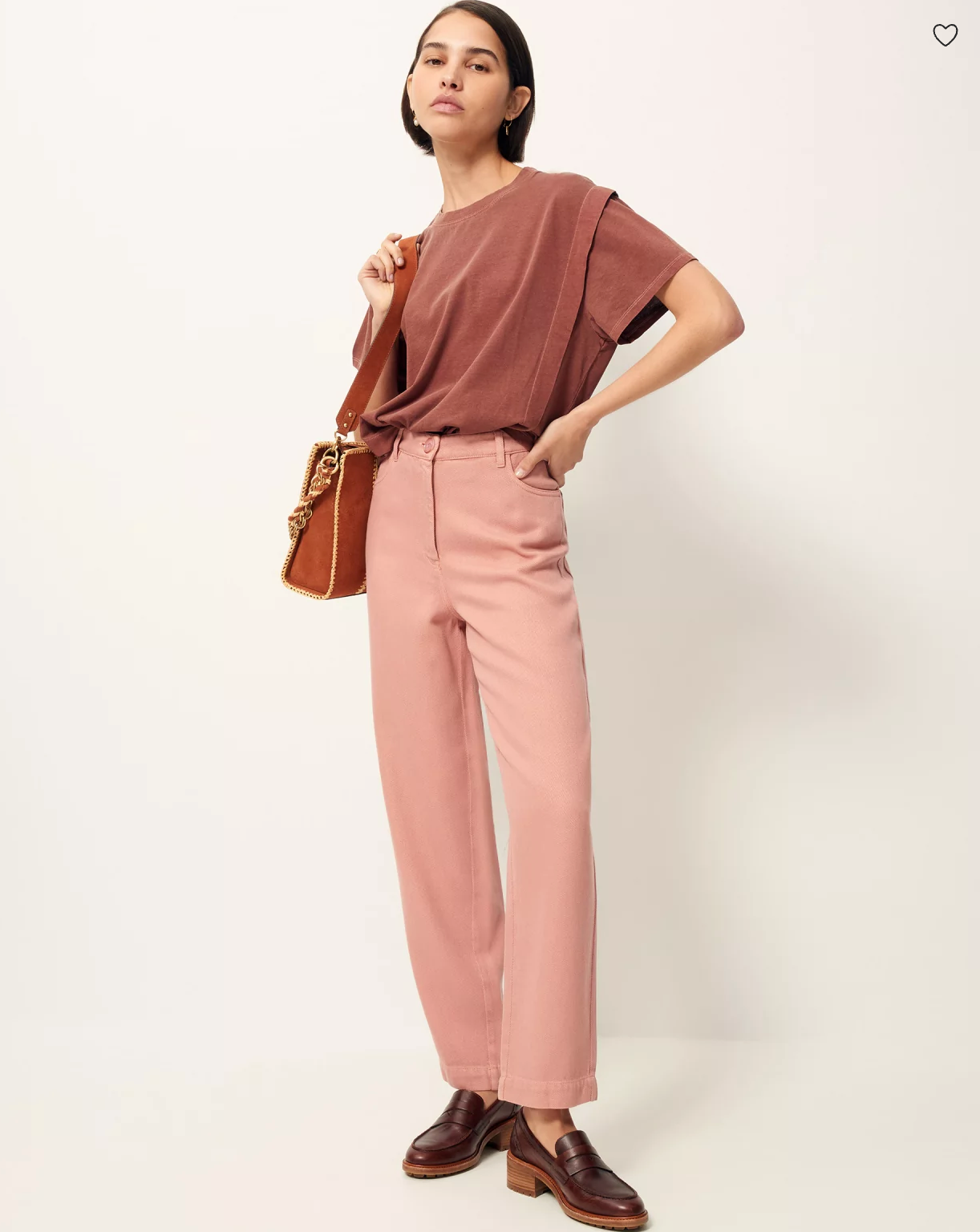 Woman wearing rose colored pants by Sessun and holding handbag