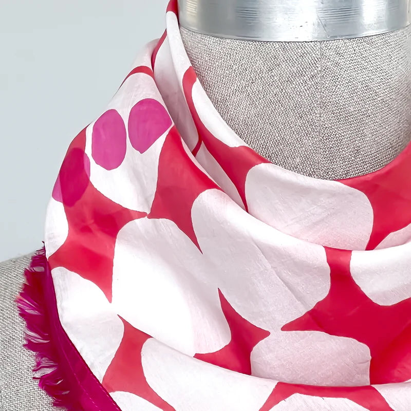 Picture of pink, red and white polkadot scarf close up on a mannequin.