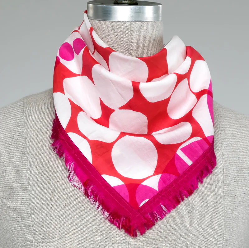 Picture of pink, red and white polkadot scarf on a mannequin.